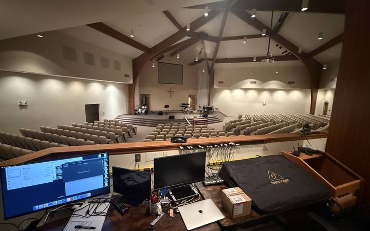 A front-of-house tech desk overlooking a sanctuary