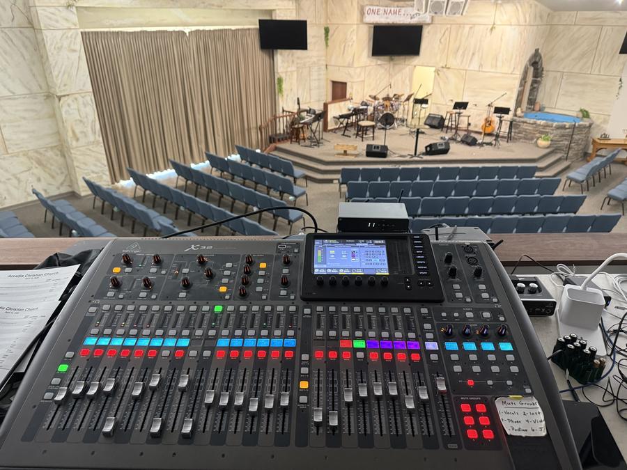 A mixing console facing a chapel stage